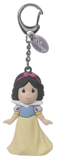 A Macanoco & Co. Disney Snow White keychain charm featuring a 3D-style figure of Snow White in her blue and yellow dress, attached to a silver lobster clasp and a Disney tag, shown on a white background.