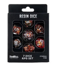A 7-piece resin RPG dice set in its original black retail packaging, featuring red and orange glittery polyhedral dice visible through a clear window.