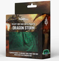 Boxed product packaging for FanRoll's 'Dragon Storm' velvet dice bag with pockets, shown on a light gray background. The front of the box features artwork of a dragon and a window displaying the green velvet bag inside.