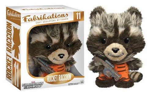 Fabrikations Rocket Raccoon soft sculpture by Enko, shown next to its original window box packaging. The plush toy is brown and gray with an orange striped shirt and holds a gray blaster.