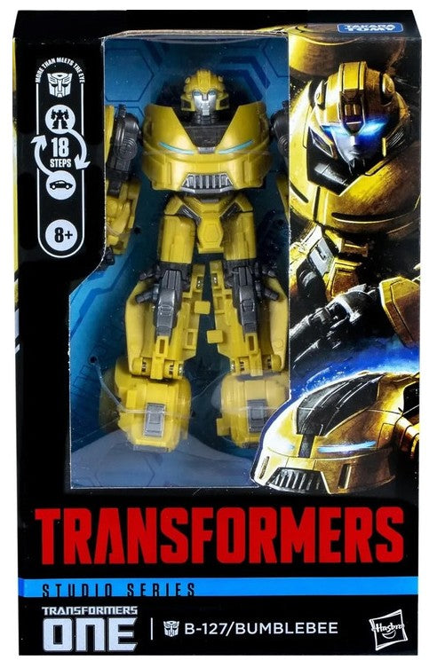 Transformers One Studio Series B-127 Bumblebee action figure in its original window box packaging, featuring a yellow and black robot design with blue accents.