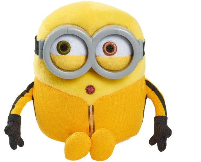 A yellow plush toy Minion with large round goggles, black gloves, and a small red mouth, shown against a plain white background.