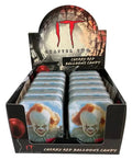 A retail display box filled with small candy tins featuring Pennywise the Clown from IT Chapter Two. The packaging and tins show cherry red balloons, with Pennywise's face on the front tins and the IT Chapter Two branding on the display.