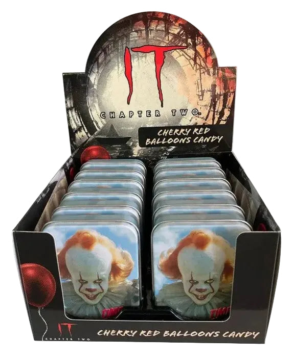 A retail display box filled with small candy tins featuring Pennywise the Clown from IT Chapter Two. The packaging and tins show cherry red balloons, with Pennywise's face on the front tins and the IT Chapter Two branding on the display.