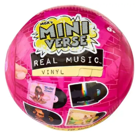 A pink spherical vinyl record toy labeled 'MGA's Mini Verse Real Music Vinyl' with album-cover style graphics and a small hand peeling back a sticker on the left side.