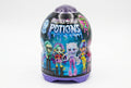 Monster High Potions blind bag toy container by Mattel, featuring colorful character illustrations and product details in French on a dark label, set on a gray textured surface.
