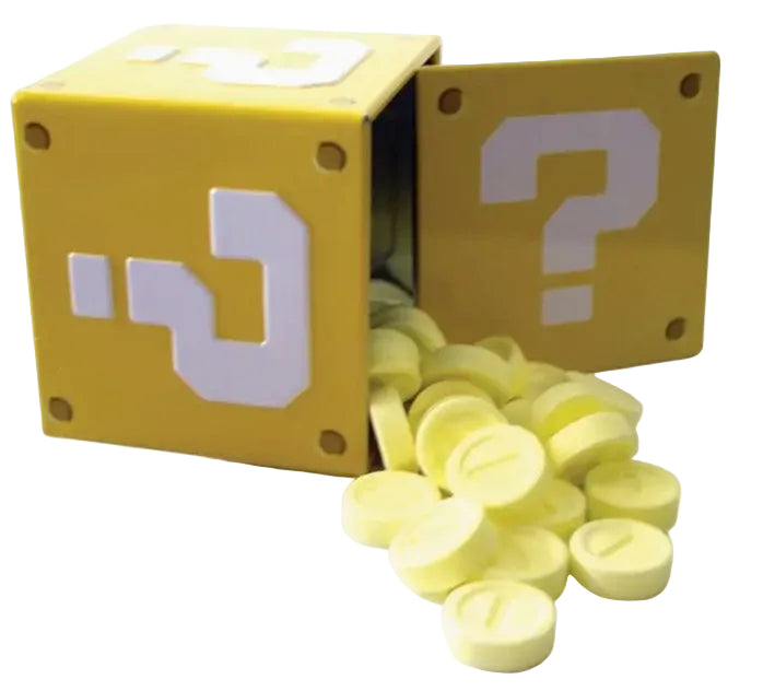 A yellow block-shaped container with a question mark on the front panel and several small round yellow coin-like pieces spilling out, photographed on a white background.