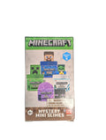 A Minecraft Mystery Mini Slimes blind box set, featuring character graphics of Steve, a Creeper, and a Zombie on the packaging, photographed on a dark desk with a keyboard in the background.